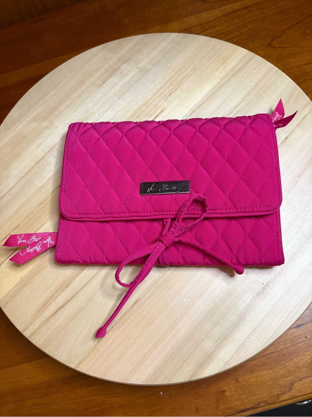 Vera Bradley "All Wrapped Up" Jewelry Roll in a fuchsia quilted microfiber.
